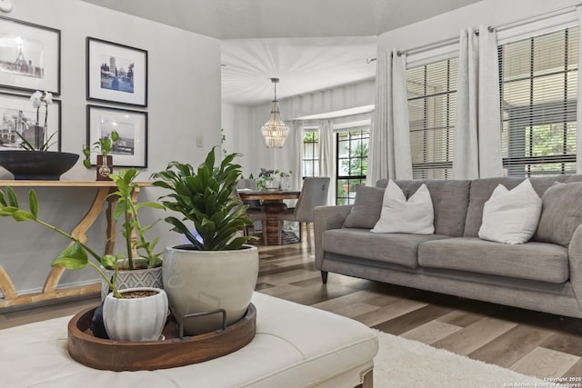 3105 Pecan Valley Dr, Temple, TX 76502 - living room featuring wood finished floors, healthy amount of natural light, and a chandelier