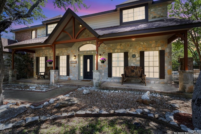 18203 Newcliff, San Antonio, TX 78259 - view of front of home featuring covered porch, stone siding, and roof with shingles