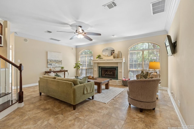 18203 Newcliff, San Antonio, TX 78259 - living area with plenty of natural light, a fireplace with raised hearth, a ceiling fan, baseboards, and ornamental molding
