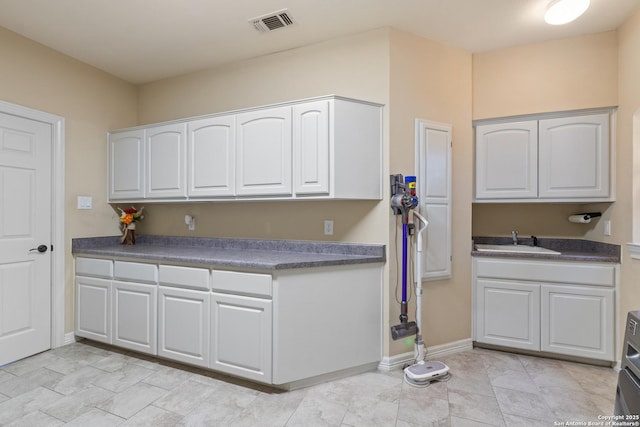 18203 Newcliff, San Antonio, TX 78259 - kitchen featuring a sink, white cabinetry, and dark countertops