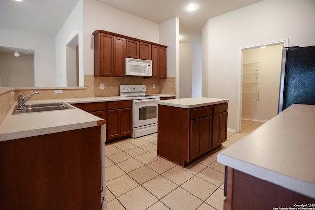 13904 Bressani Way, Live Oak, TX 78233 - kitchen with white appliances, a sink, decorative backsplash, light tile patterned flooring, and light countertops