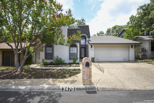3470 River Path, San Antonio, TX 78230 - view of front of house with roof with shingles, an attached garage, concrete driveway, and stucco siding