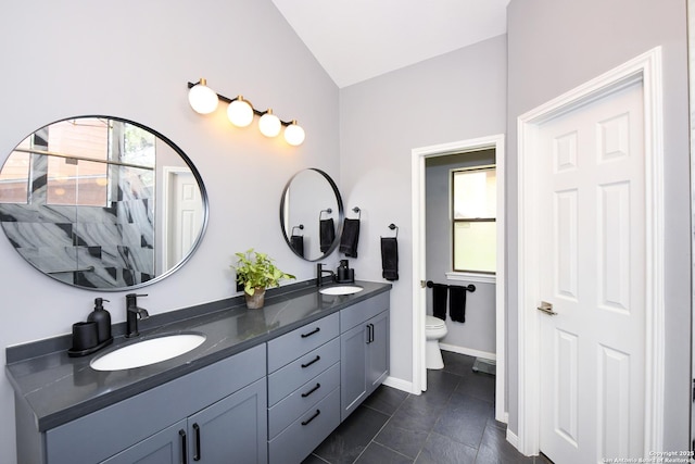 3470 River Path, San Antonio, TX 78230 - full bathroom with double vanity, lofted ceiling, toilet, tile patterned floors, and baseboards