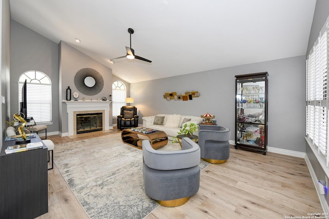 3470 River Path, San Antonio, TX 78230 - living area with ceiling fan, lofted ceiling, a tile fireplace, wood finished floors, and baseboards