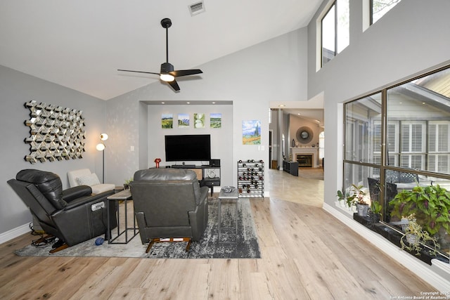 3470 River Path, San Antonio, TX 78230 - living room with wood finished floors, a ceiling fan, baseboards, a fireplace, and vaulted ceiling