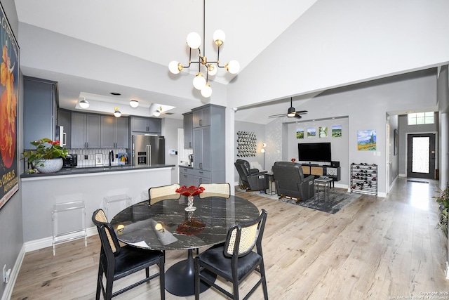 3470 River Path, San Antonio, TX 78230 - dining room featuring a chandelier, light wood-style floors, a ceiling fan, baseboards, and high vaulted ceiling