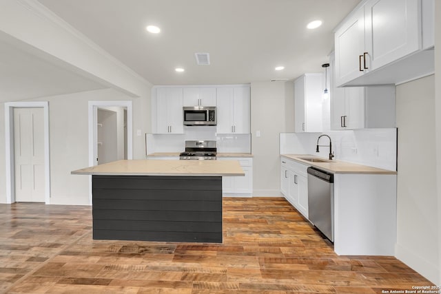 339 Thorain Blvd, San Antonio, TX 78212 - kitchen with stainless steel appliances, a sink, backsplash, a center island, and recessed lighting