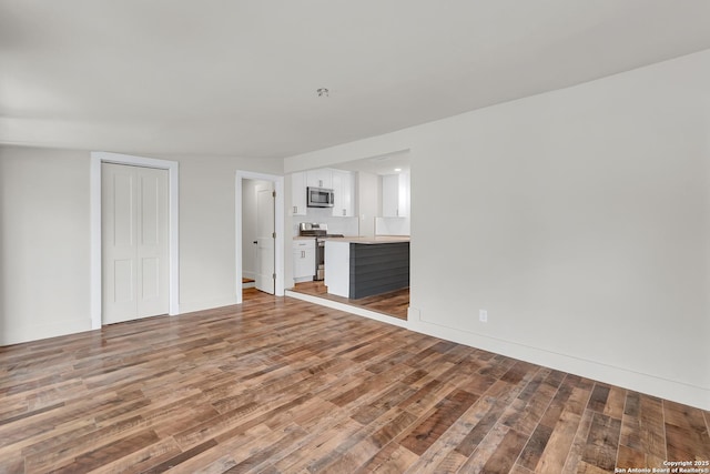 339 Thorain Blvd, San Antonio, TX 78212 - unfurnished living room featuring light wood-style floors and baseboards