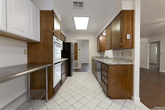 109 Sumac, New Braunfels, TX 78130 - kitchen with a sink, stainless steel appliances, baseboards, and white cabinets