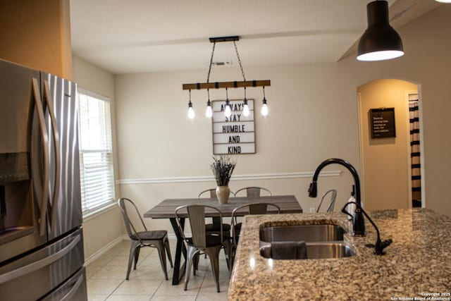2073 Robin Hood, Canyon Lake, TX 78133 - dining room featuring light tile patterned floors, arched walkways, and baseboards