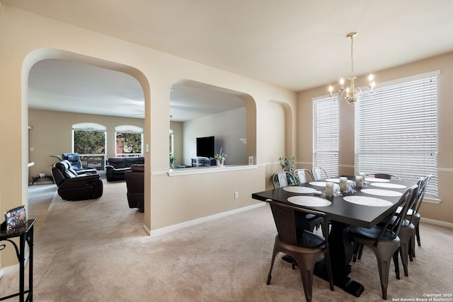 20710 Meandering Cir, San Antonio, TX 78258 - carpeted dining area with arched walkways, a chandelier, and baseboards
