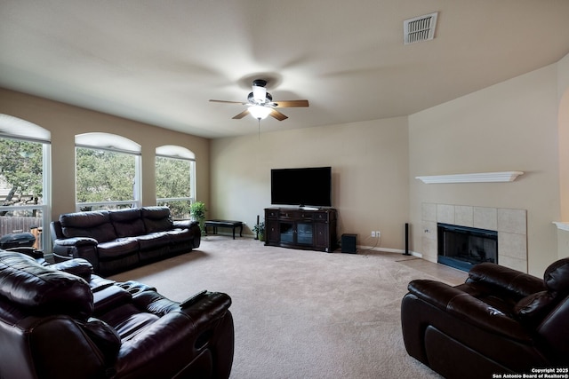 20710 Meandering Cir, San Antonio, TX 78258 - carpeted living area featuring a tile fireplace and ceiling fan