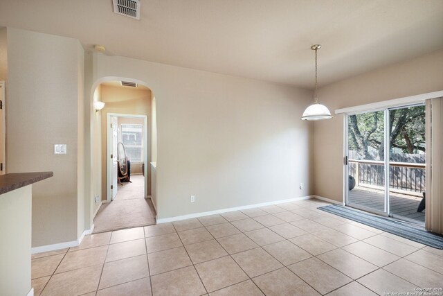 20710 Meandering Cir, San Antonio, TX 78258 - unfurnished room featuring arched walkways, light tile patterned floors, and baseboards
