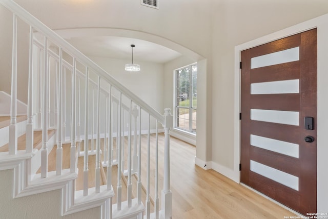 907 Amigo, San Antonio, TX 78260 - entryway featuring arched walkways, light wood-style flooring, stairway, and baseboards