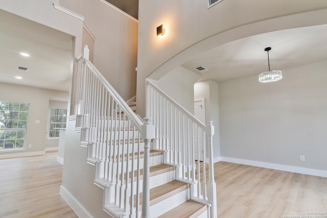 907 Amigo, San Antonio, TX 78260 - staircase with wood finished floors, arched walkways, baseboards, and a chandelier
