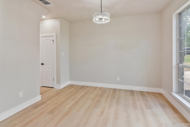 907 Amigo, San Antonio, TX 78260 - unfurnished room with wood finished floors, baseboards, and a chandelier