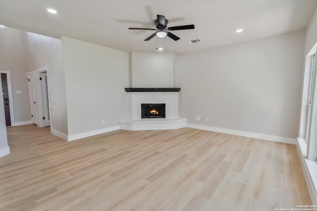 907 Amigo, San Antonio, TX 78260 - unfurnished living room with a brick fireplace, wood finished floors, a ceiling fan, baseboards, and recessed lighting
