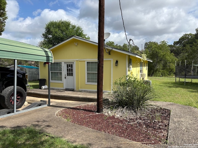 952 Madrona Rd, Pipe Creek, TX 78063 - view of property exterior with a trampoline and a lawn