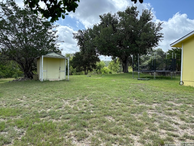 952 Madrona Rd, Pipe Creek, TX 78063 - view of grassy yard featuring a trampoline