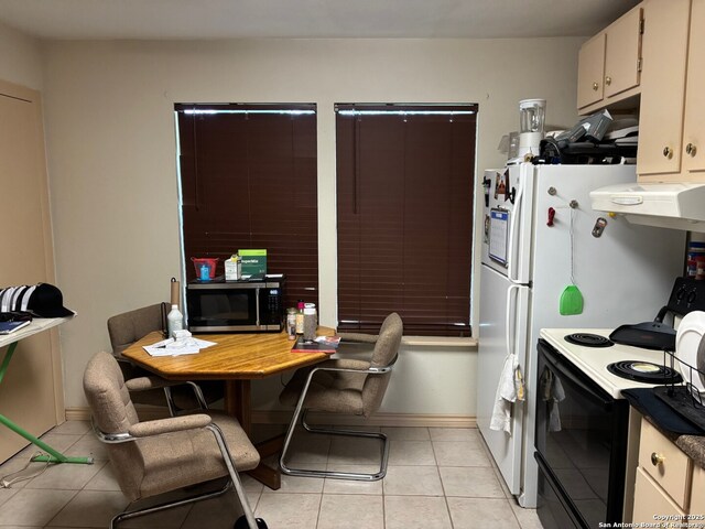 952 Madrona Rd, Pipe Creek, TX 78063 - kitchen with range with electric cooktop, exhaust hood, stainless steel microwave, light tile patterned floors, and baseboards