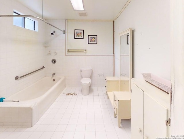 519 Huisache, San Antonio, TX 78212 - full bath featuring tile patterned floors, toilet, shower / bathtub combination, vanity, and tile walls