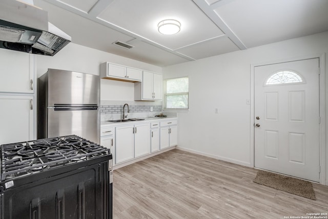 326 Sublett, San Antonio, TX 78223 - kitchen featuring freestanding refrigerator, ventilation hood, a sink, and light wood finished floors