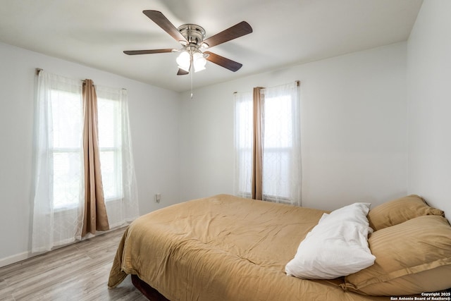 326 Sublett, San Antonio, TX 78223 - bedroom featuring light wood-style flooring, ceiling fan, and baseboards