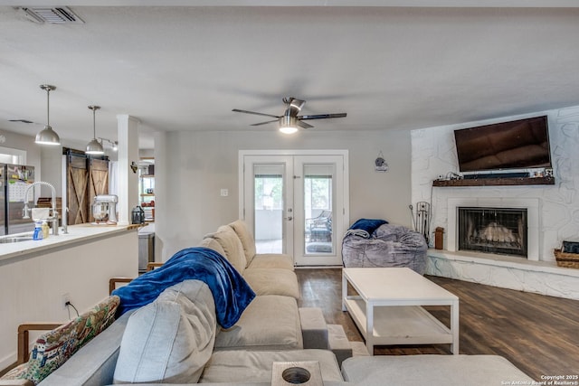 6034 Royal, San Antonio, TX 78239 - living area featuring wood finished floors, a ceiling fan, and a fireplace