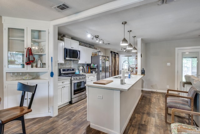 6034 Royal, San Antonio, TX 78239 - kitchen featuring stainless steel appliances, a sink, dark wood-style flooring, and white cabinetry