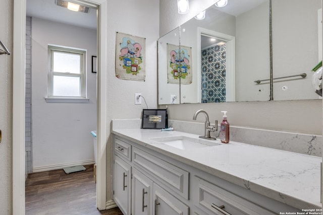 6034 Royal, San Antonio, TX 78239 - full bath featuring vanity, wood finished floors, and baseboards