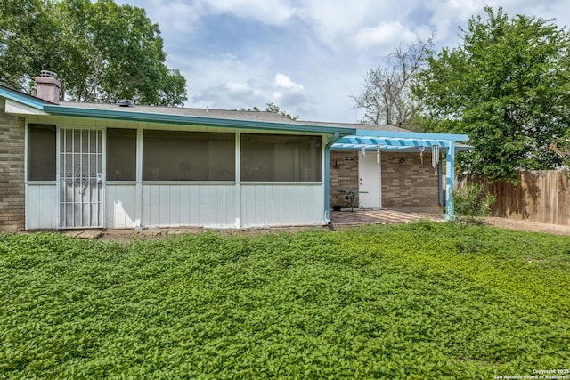 6034 Royal, San Antonio, TX 78239 - rear view of house featuring a pergola, brick siding, a chimney, and a sunroom