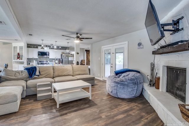 6034 Royal, San Antonio, TX 78239 - living area with a ceiling fan, a fireplace with raised hearth, wood finished floors, and french doors