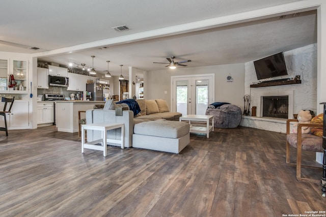 6034 Royal, San Antonio, TX 78239 - living room featuring dark wood-style flooring, ceiling fan, and a large fireplace
