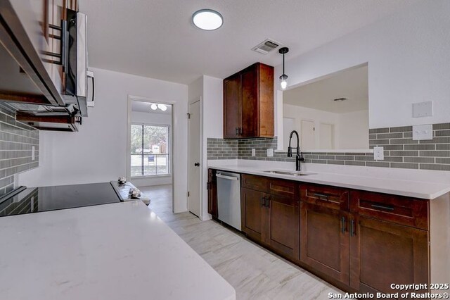 3250 Bear Spgs, San Antonio, TX 78245 - kitchen featuring dishwasher, a sink, light countertops, and backsplash