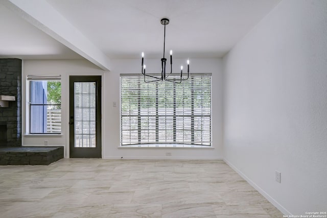 3250 Bear Spgs, San Antonio, TX 78245 - unfurnished dining area featuring a chandelier, marble finish flooring, baseboards, and a fireplace