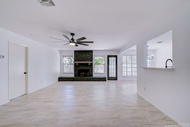 3250 Bear Spgs, San Antonio, TX 78245 - unfurnished living room with a ceiling fan, a stone fireplace, light marble finish floors, and a sink