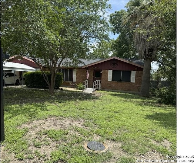 1149 Spruce, Seguin, TX 78155 - single story home with brick siding, a front lawn, and a detached carport