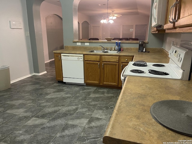 4122 Chinkapin Oak, San Antonio, TX 78223 - kitchen featuring white appliances, a sink, arched walkways, brown cabinetry, and lofted ceiling