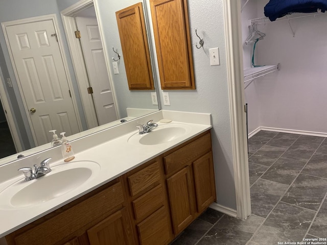 4122 Chinkapin Oak, San Antonio, TX 78223 - bathroom with double vanity, a spacious closet, and baseboards