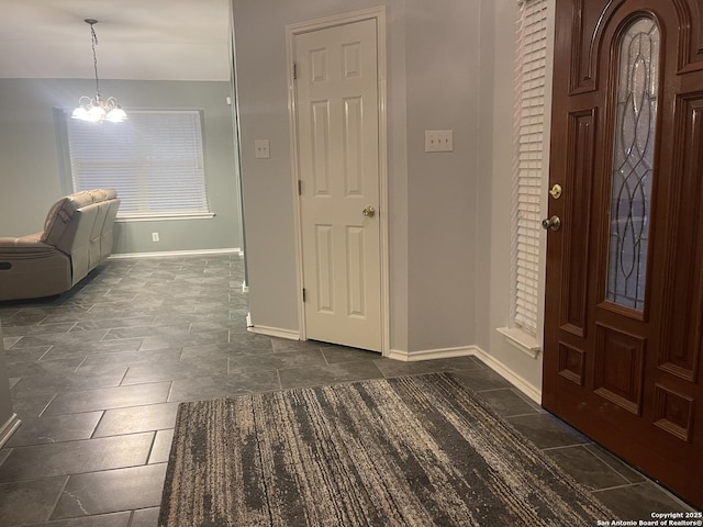 4122 Chinkapin Oak, San Antonio, TX 78223 - foyer entrance featuring baseboards, a chandelier, and dark stone finish floors