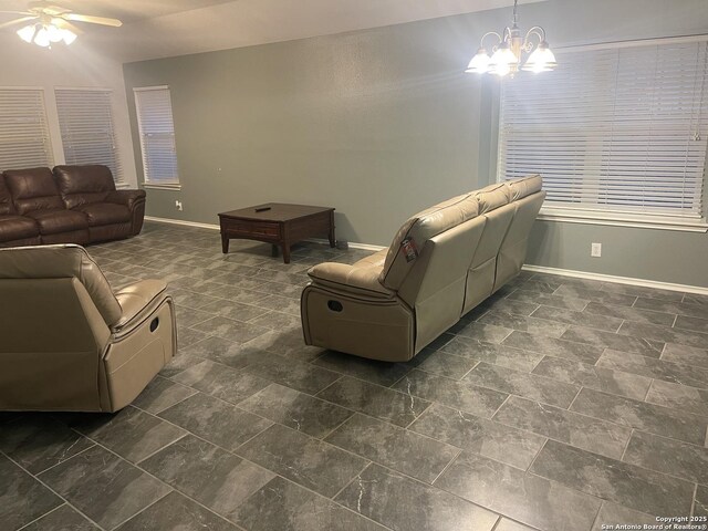 4122 Chinkapin Oak, San Antonio, TX 78223 - living room with a ceiling fan, baseboards, and a chandelier