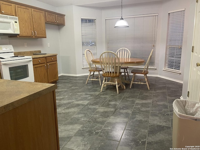 4122 Chinkapin Oak, San Antonio, TX 78223 - dining room featuring baseboards and dark stone finish flooring