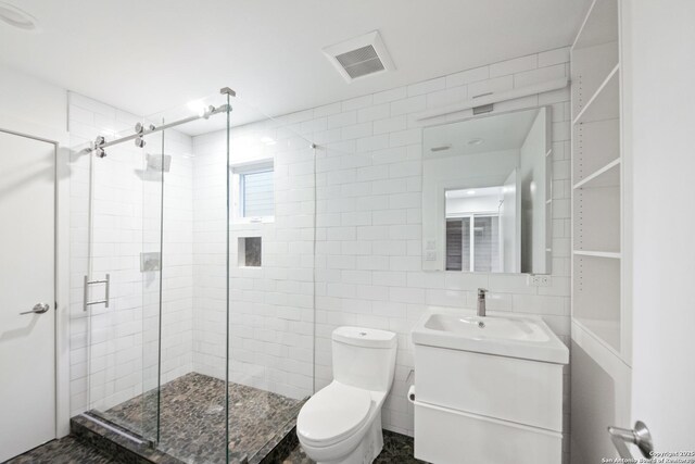 543 Leigh, San Antonio, TX 78210 - full bathroom featuring a stall shower, vanity, and tile walls