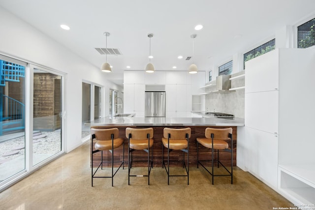 543 Leigh, San Antonio, TX 78210 - kitchen with appliances with stainless steel finishes, modern cabinets, ventilation hood, white cabinetry, and backsplash