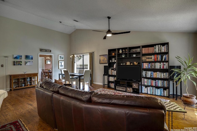 7011 Washita Way, San Antonio, TX 78256 - living room with ceiling fan, vaulted ceiling, wood finished floors, and a textured ceiling