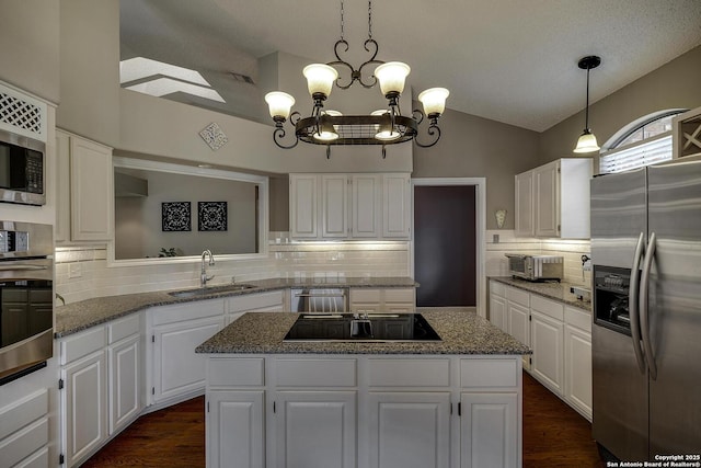 7011 Washita Way, San Antonio, TX 78256 - kitchen featuring stainless steel appliances, a sink, a center island, a chandelier, and decorative backsplash