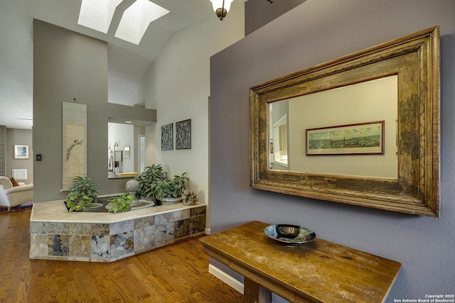 7011 Washita Way, San Antonio, TX 78256 - corridor with a skylight, wood finished floors, and high vaulted ceiling