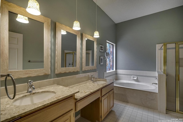 7011 Washita Way, San Antonio, TX 78256 - bathroom featuring tile patterned flooring, a bath, double vanity, lofted ceiling, and a stall shower
