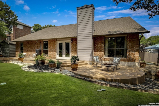 7011 Washita Way, San Antonio, TX 78256 - back of property featuring french doors, an outdoor fire pit, brick siding, and a patio