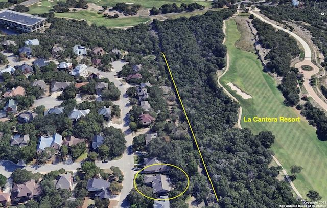 7011 Washita Way, San Antonio, TX 78256 - aerial overview of property's location featuring a golf course, nearby suburban area, and a tree filled landscape